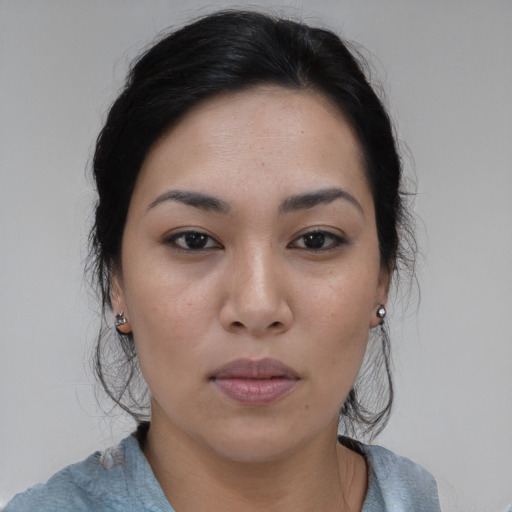 Joyful asian young-adult female with medium  black hair and brown eyes
