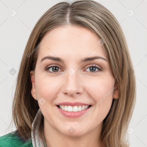 Joyful white young-adult female with medium  brown hair and green eyes