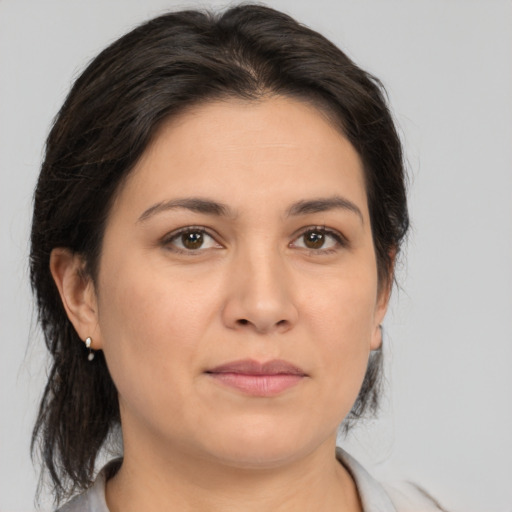 Joyful white young-adult female with medium  brown hair and brown eyes