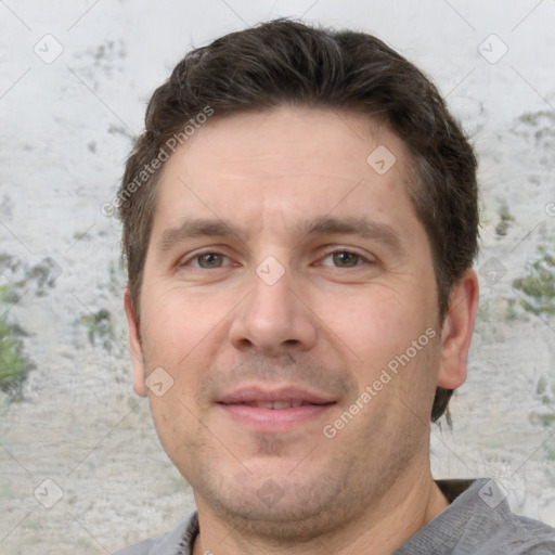 Joyful white adult male with short  brown hair and grey eyes