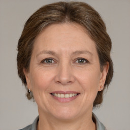 Joyful white adult female with medium  brown hair and grey eyes