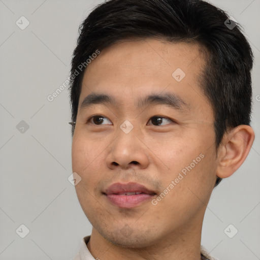 Joyful asian young-adult male with short  brown hair and brown eyes