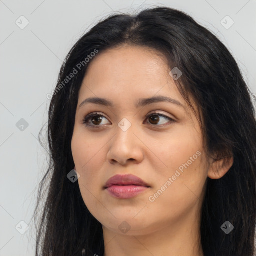 Joyful latino young-adult female with long  black hair and brown eyes