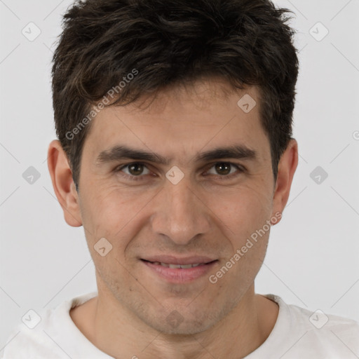 Joyful white young-adult male with short  brown hair and brown eyes