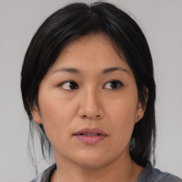 Neutral asian young-adult female with medium  brown hair and brown eyes