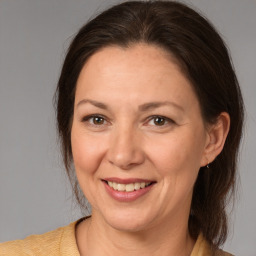 Joyful white adult female with medium  brown hair and brown eyes