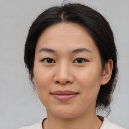 Joyful asian young-adult female with medium  brown hair and brown eyes