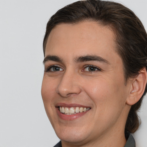 Joyful white young-adult male with medium  brown hair and brown eyes