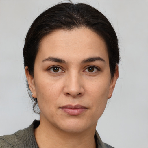 Joyful white young-adult female with medium  brown hair and brown eyes