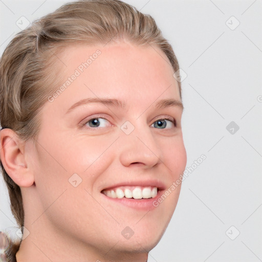 Joyful white young-adult female with short  brown hair and blue eyes