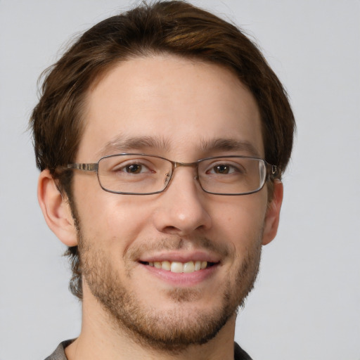 Joyful white young-adult male with short  brown hair and green eyes