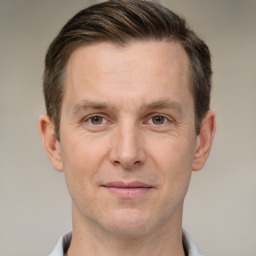 Joyful white adult male with short  brown hair and grey eyes