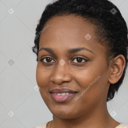 Joyful black young-adult female with short  black hair and brown eyes