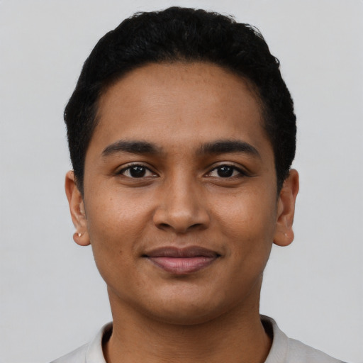 Joyful latino young-adult male with short  black hair and brown eyes