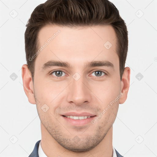 Joyful white young-adult male with short  brown hair and grey eyes