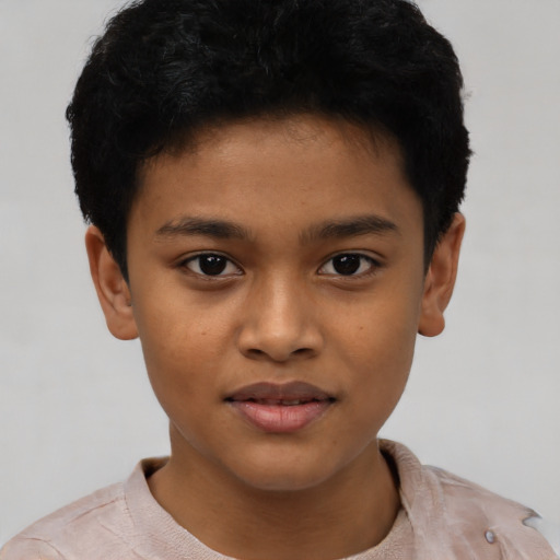 Joyful latino child male with short  black hair and brown eyes