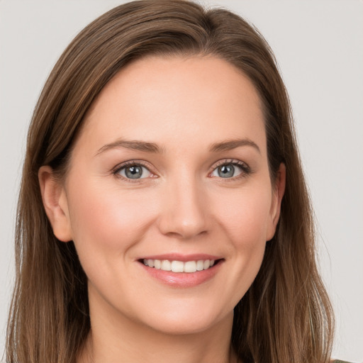 Joyful white young-adult female with long  brown hair and grey eyes