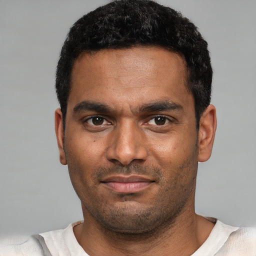 Neutral black young-adult male with short  black hair and brown eyes