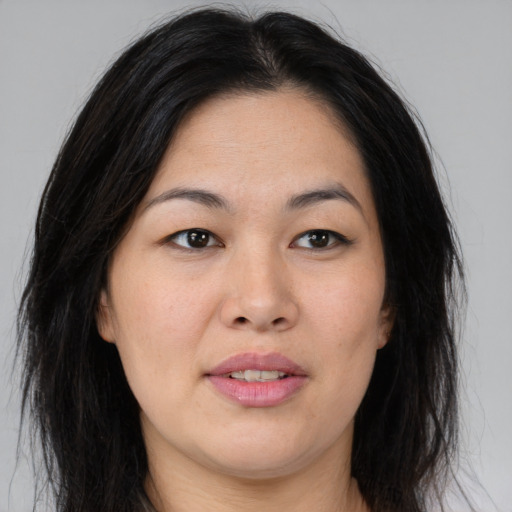 Joyful asian young-adult female with medium  brown hair and brown eyes