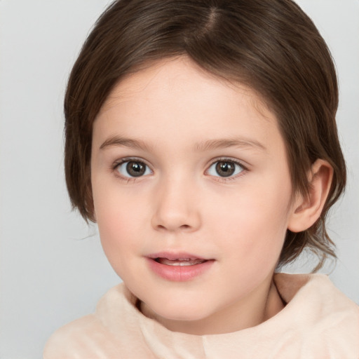 Joyful white child female with medium  brown hair and brown eyes