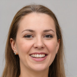 Joyful white young-adult female with long  brown hair and grey eyes