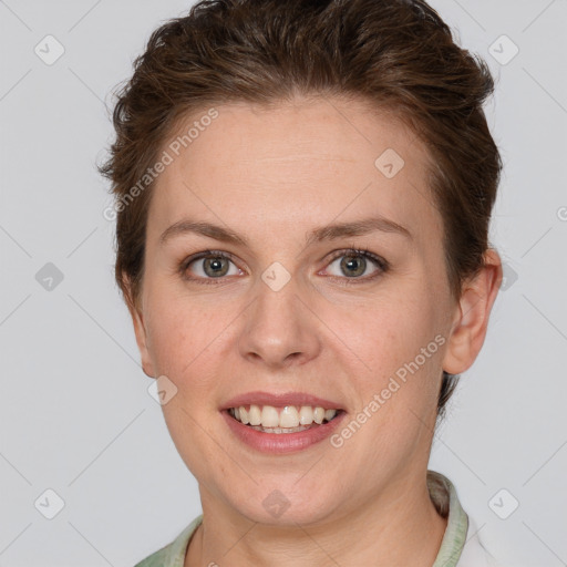 Joyful white young-adult female with short  brown hair and grey eyes