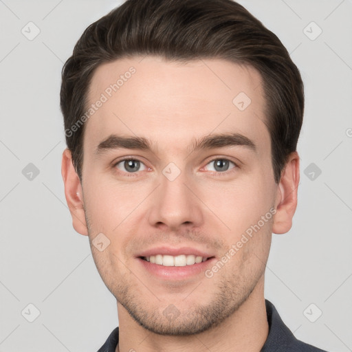 Joyful white young-adult male with short  brown hair and grey eyes