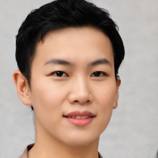 Joyful asian young-adult male with short  brown hair and brown eyes