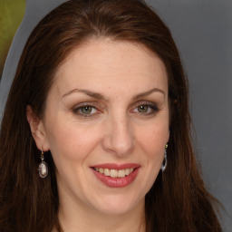 Joyful white adult female with long  brown hair and grey eyes