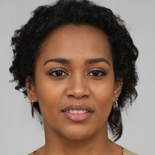 Joyful black young-adult female with medium  black hair and brown eyes