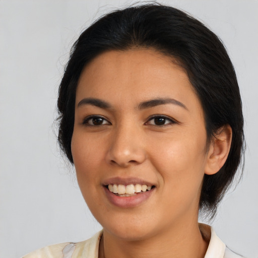 Joyful latino young-adult female with medium  black hair and brown eyes