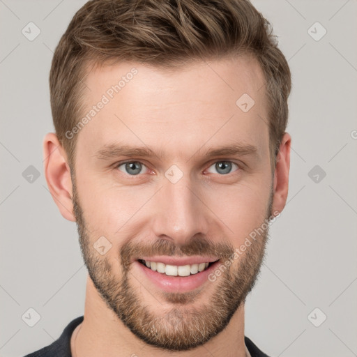 Joyful white young-adult male with short  brown hair and grey eyes