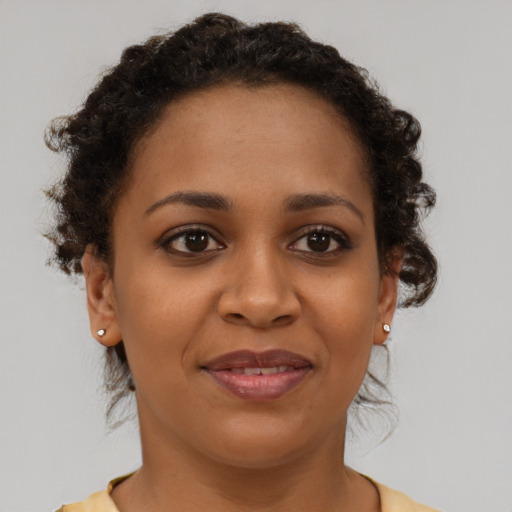Joyful black young-adult female with short  brown hair and brown eyes