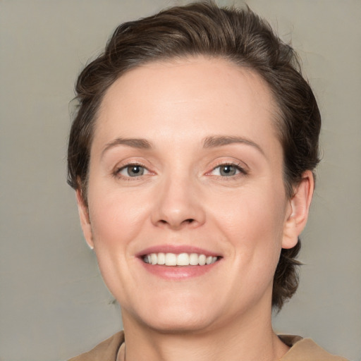 Joyful white young-adult female with medium  brown hair and grey eyes