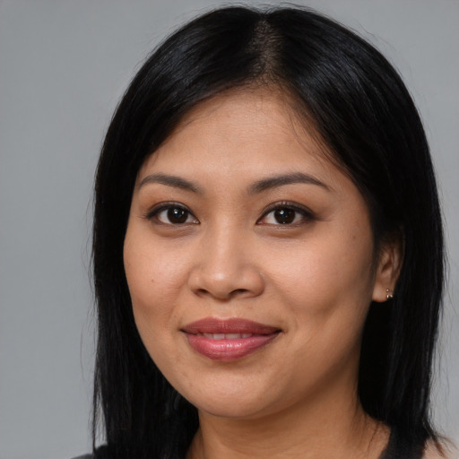 Joyful asian young-adult female with long  black hair and brown eyes