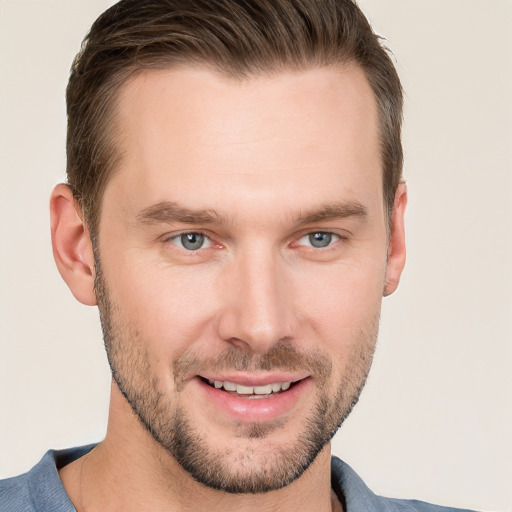 Joyful white young-adult male with short  brown hair and grey eyes