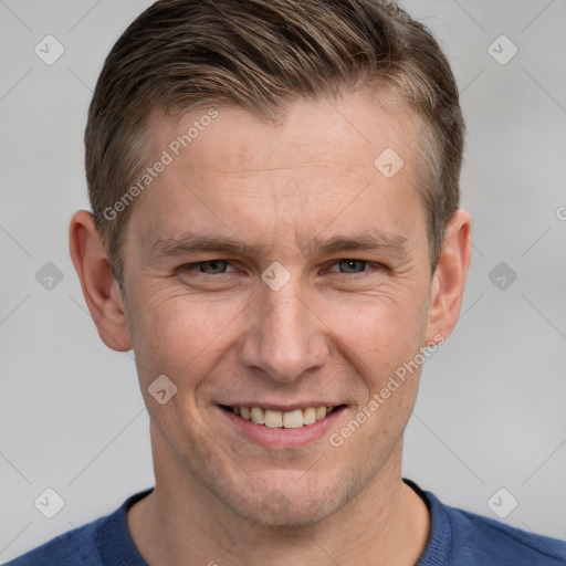 Joyful white adult male with short  brown hair and grey eyes