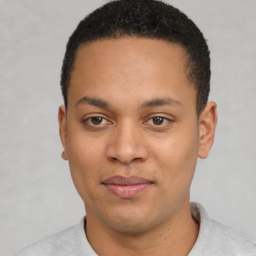 Joyful latino young-adult male with short  brown hair and brown eyes