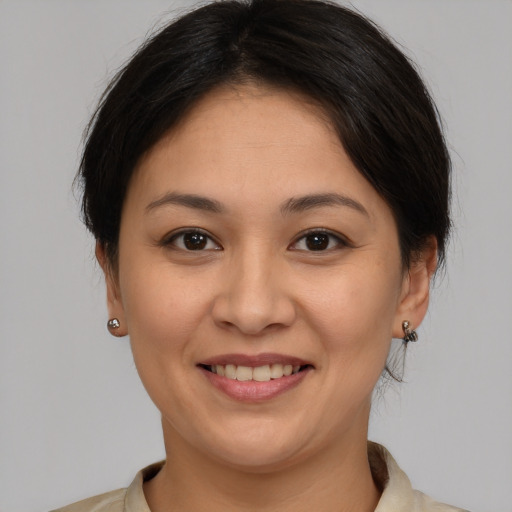 Joyful white young-adult female with medium  brown hair and brown eyes