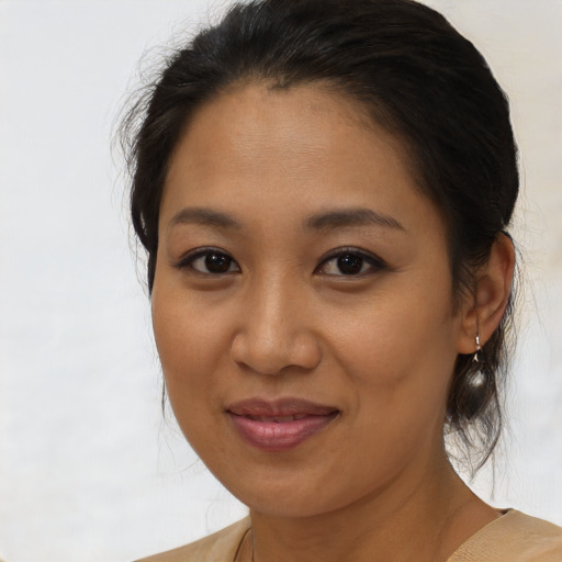 Joyful latino young-adult female with medium  brown hair and brown eyes