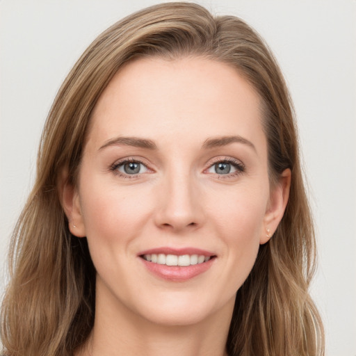 Joyful white young-adult female with long  brown hair and blue eyes