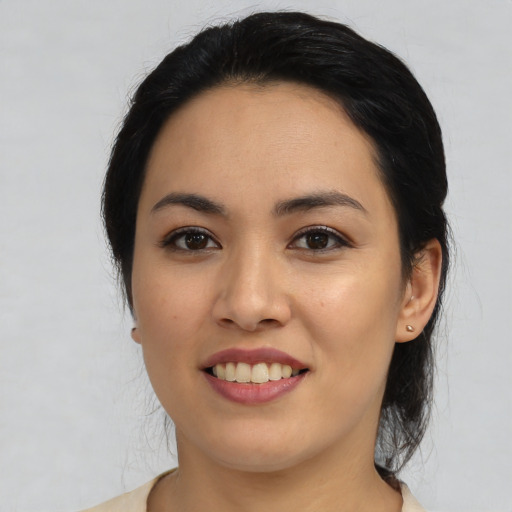 Joyful latino young-adult female with medium  black hair and brown eyes