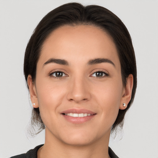 Joyful white young-adult female with medium  brown hair and brown eyes