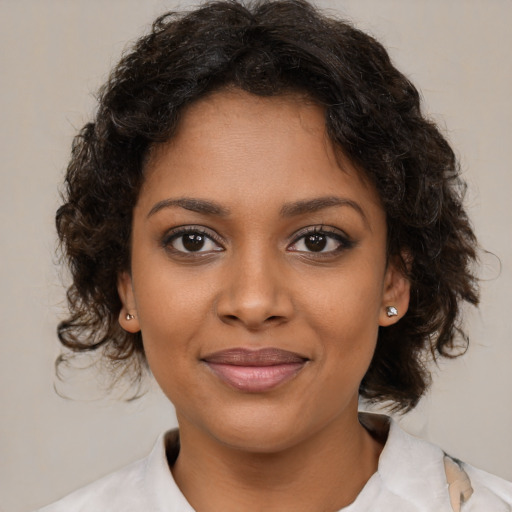 Joyful black young-adult female with medium  brown hair and brown eyes