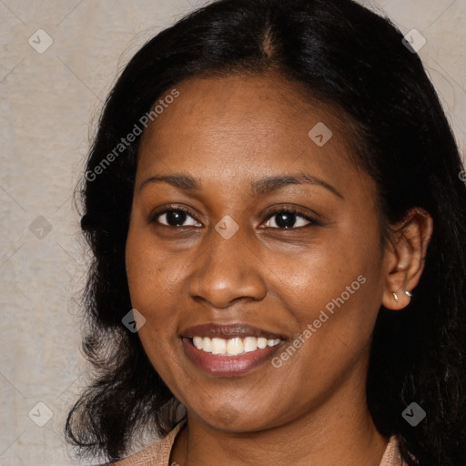 Joyful black young-adult female with long  brown hair and brown eyes