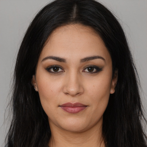 Joyful latino young-adult female with long  brown hair and brown eyes