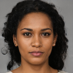 Neutral black young-adult female with medium  brown hair and brown eyes