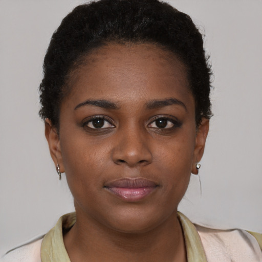 Joyful black young-adult female with short  brown hair and brown eyes