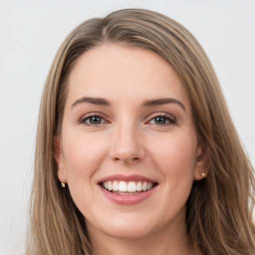 Joyful white young-adult female with long  brown hair and grey eyes