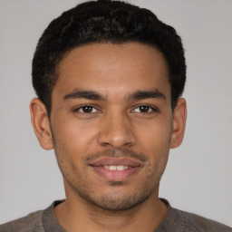 Joyful latino young-adult male with short  brown hair and brown eyes